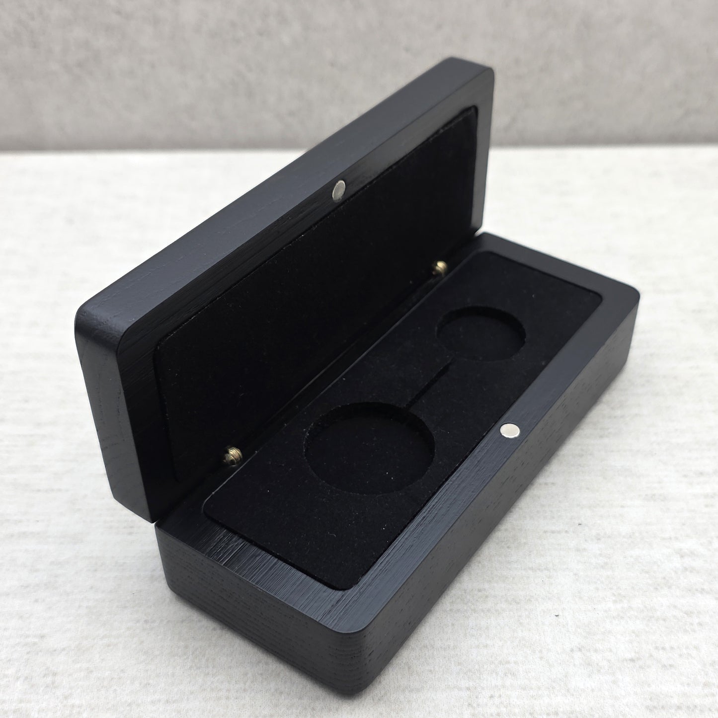 Open black solid ash wood display case side view featuring black velvet padded insert and magnetic closure