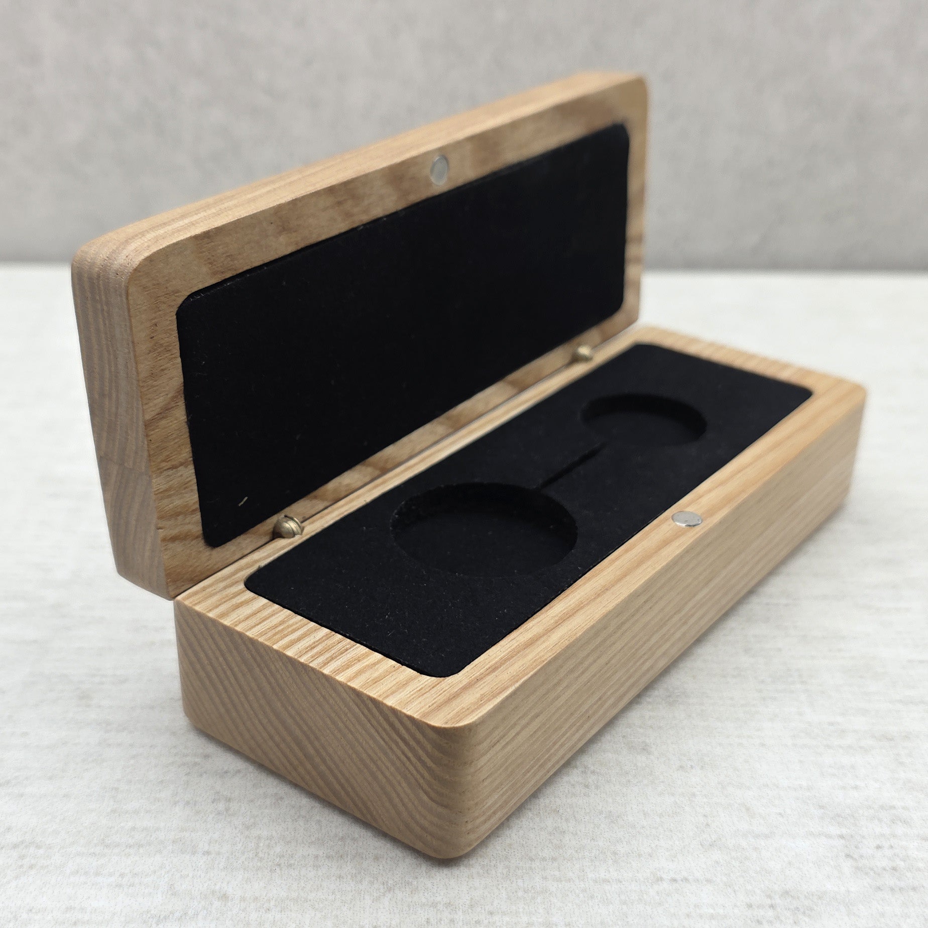 Open solid ash wood presentation box side view with black velvet foam insert and magnetic closure