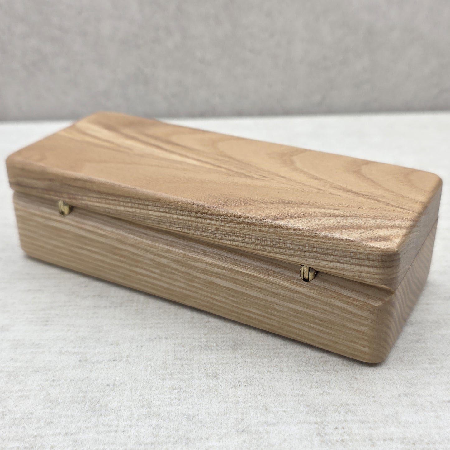 Closed natural ash wood gift case back view showing durable brass hinges and solid wood construction