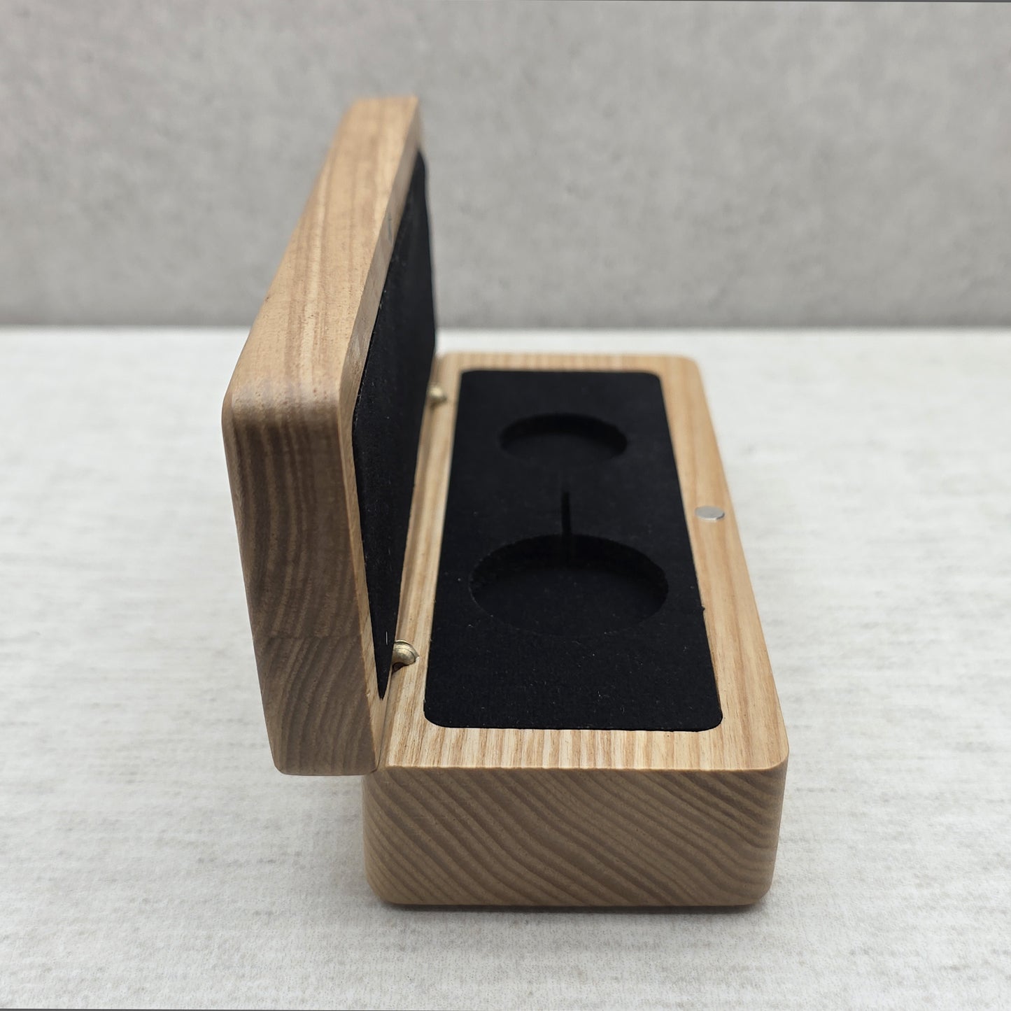 Open natural ash wood pendant display case front view featuring black velvet padded insert and rounded edges
