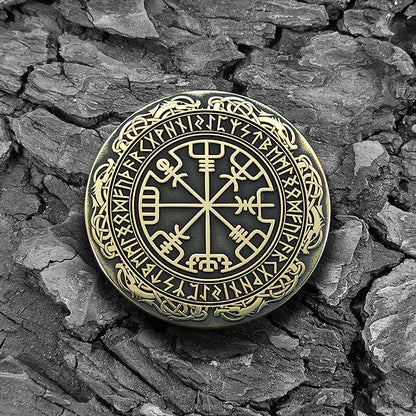 Scandinavian brass coin Vegvisir on a natural bark background highlighting antique patina.