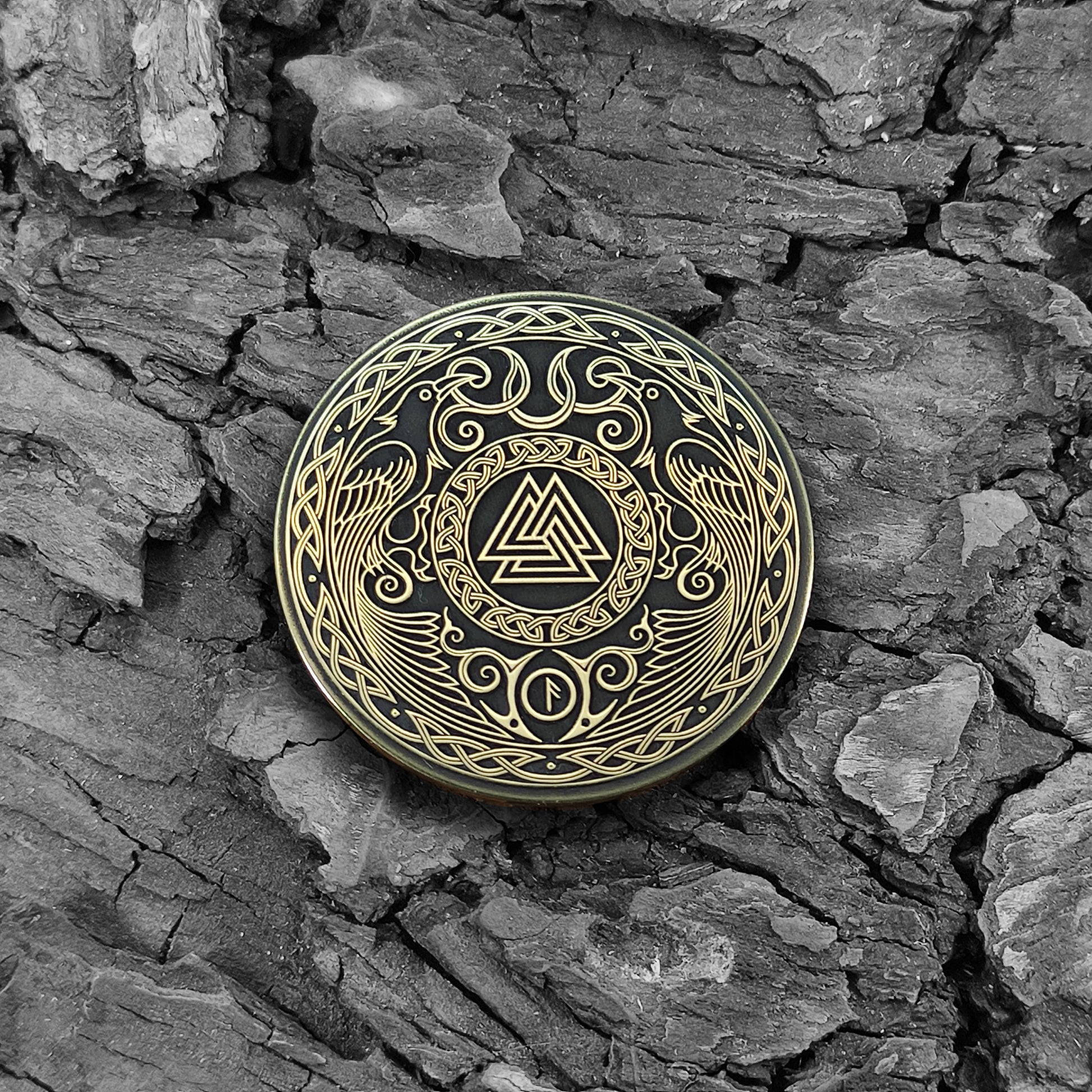 Viking Valknut brass coin on a natural bark background, highlighting the aged patina and ancient Nordic symbolic aesthetic.