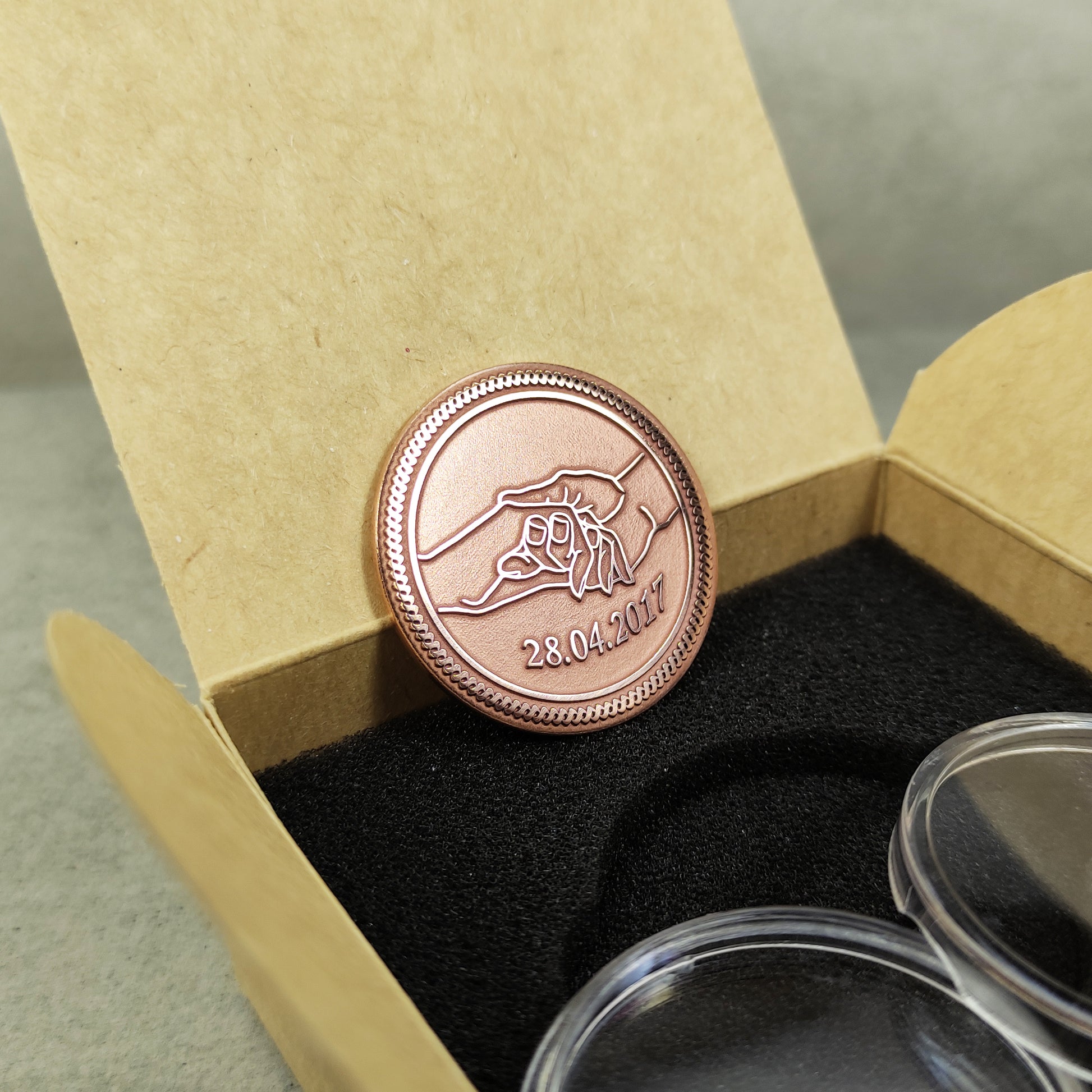 Handcrafted copper anniversary coin standing in a craft gift box, showcasing the 32mm diameter and professional deep laser etching.
