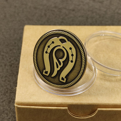 Angled view of an engraved brass prosperity coin showing detailed relief carving and antique metal finish.