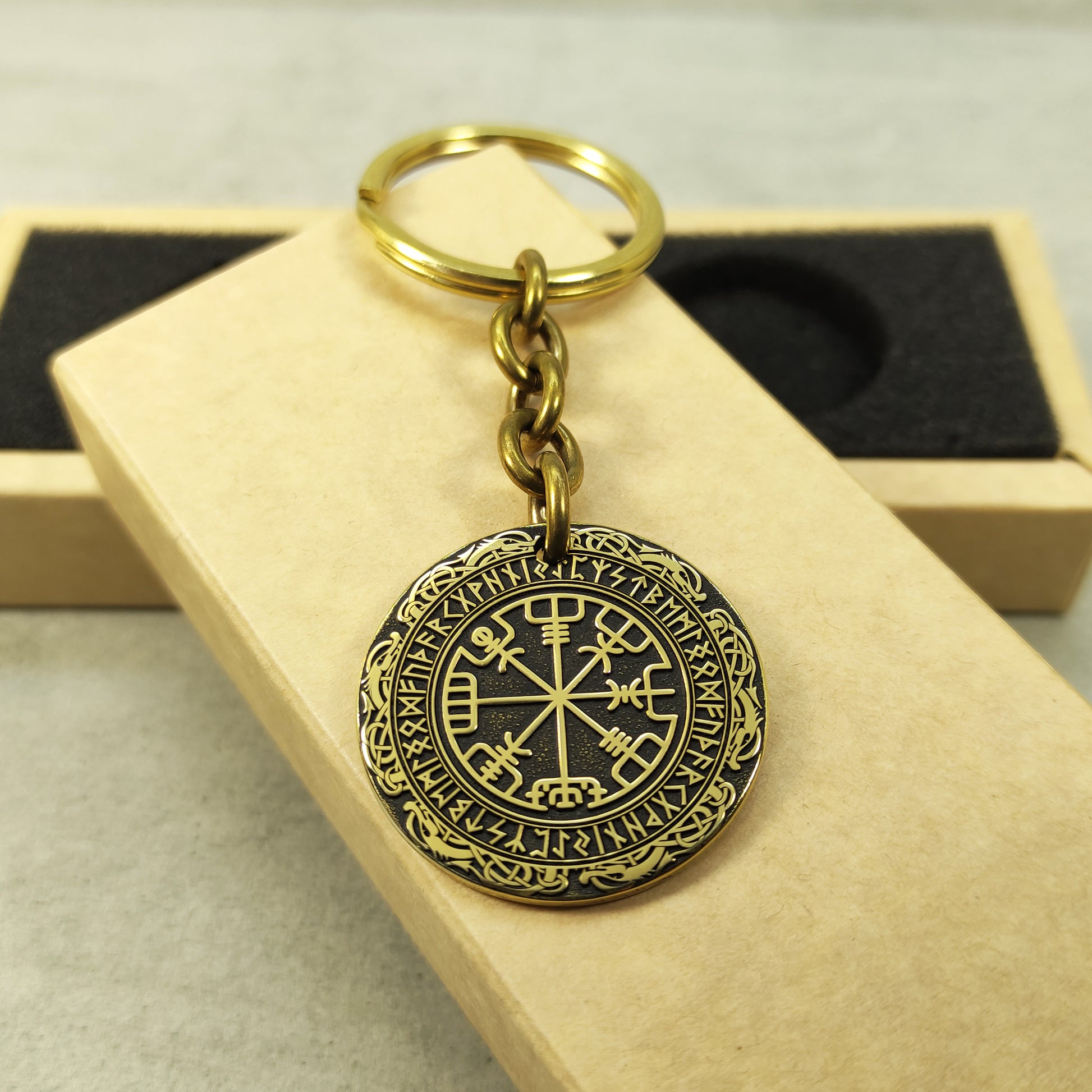 Handcrafted brass Vegvisir medal keychain presented on a rustic gift box, showcasing the 32mm diameter and professional deep laser etching.
