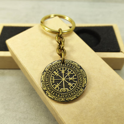 Handcrafted brass Vegvisir medal keychain presented on a rustic gift box, showcasing the 32mm diameter and professional deep laser etching.