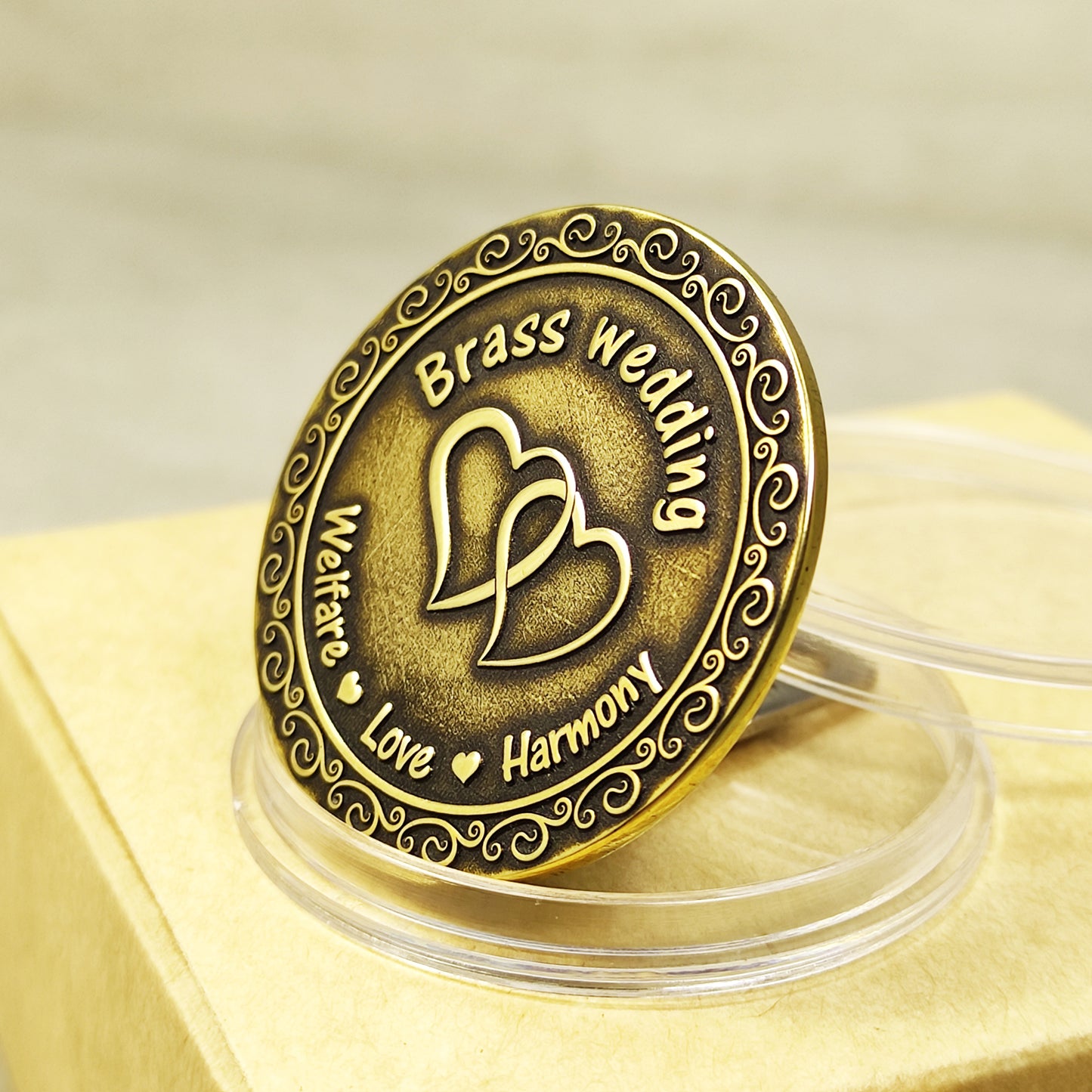 Side view of hand-polished brass coin for 21st wedding anniversary, showing deep relief engraving and aged brass finish.