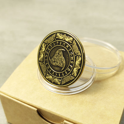 Top view of a brass Norse Triple Horn amulet coin featuring intricate runic circle engraving and high-contrast antique finish.