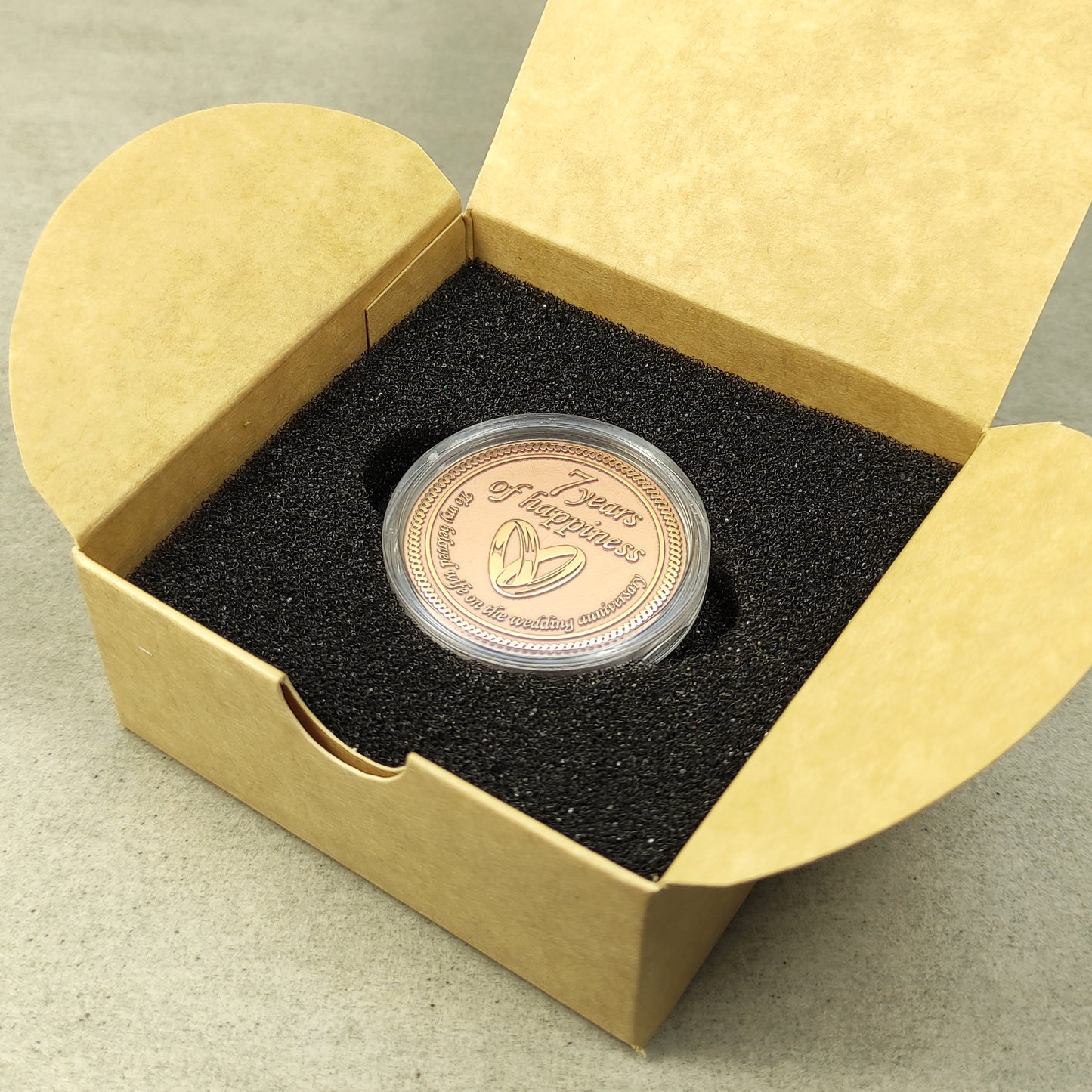 Engraved copper anniversary coin for wife, personalized 7 years of marriage celebration gift inside a craft paper box with foam insert.