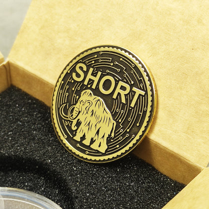 Handcrafted brass decision coin with high-contrast black patina and detailed mammoth illustration.