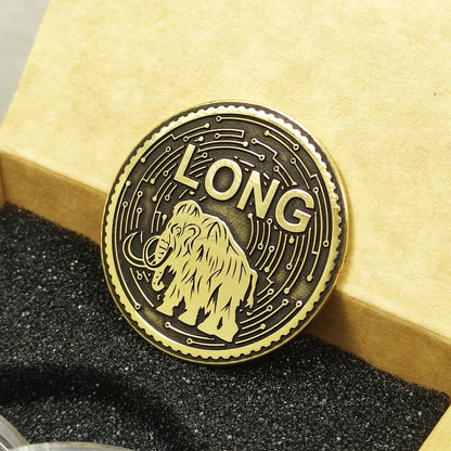 Close-up of premium polished brass mammoth coin showing deep laser etching and decorative borders.