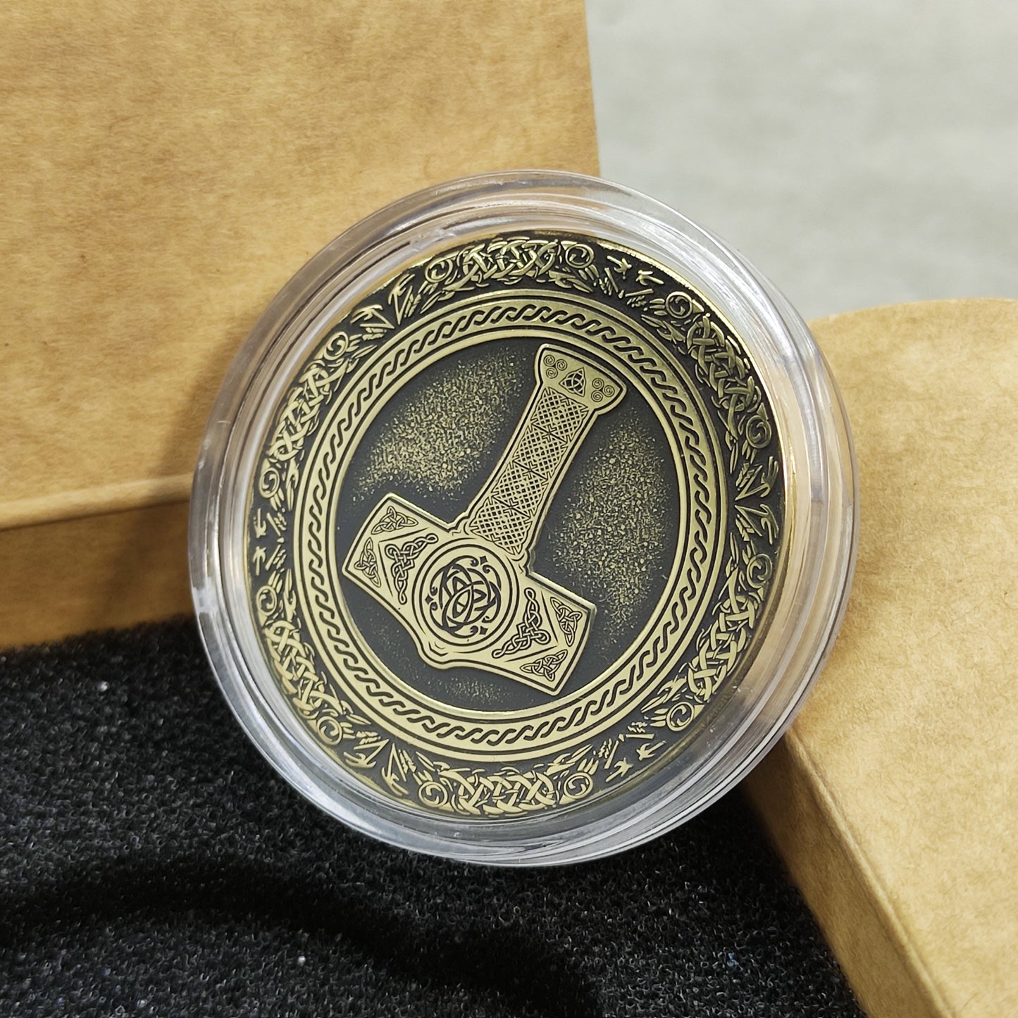 Close-up of the intricate Norse runes and Celtic knotwork on the antique brass surface.