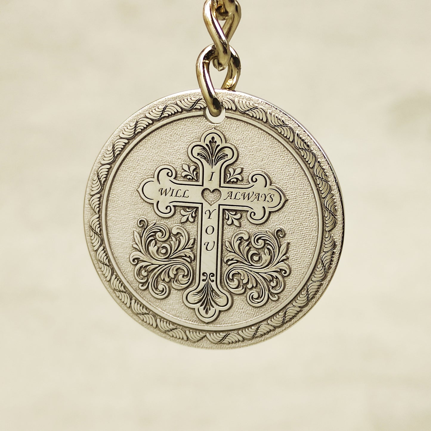 Reverse side of stainless steel keychain featuring custom engraved quote and decorative circular borders.