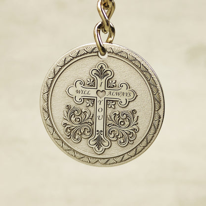 Reverse side of stainless steel keychain featuring custom engraved quote and decorative circular borders.
