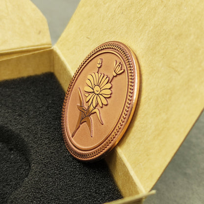Vertical view of the custom copper commemorative coin in a premium insert box, showcasing the antique-style matte surface and artistic flower relief.