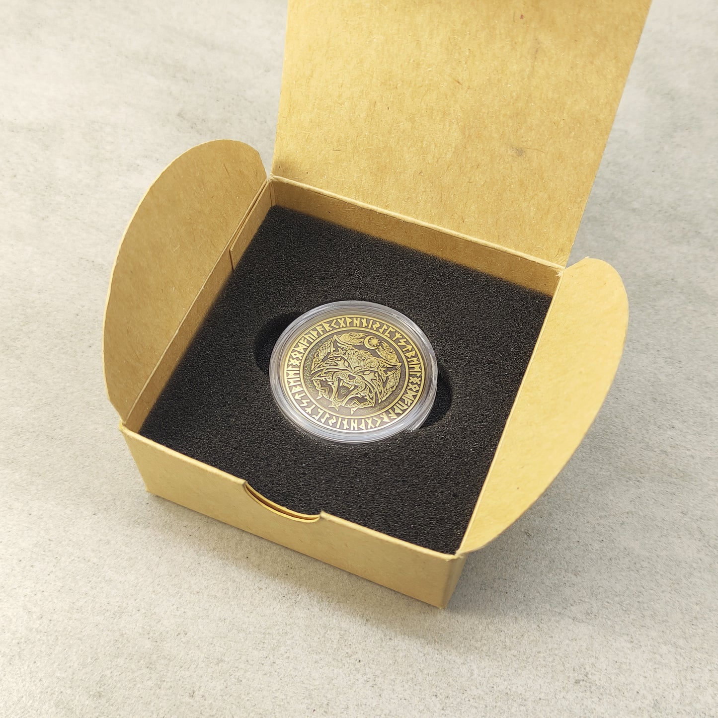 Personalized Fenrir Wolf brass coin in a protective capsule and craft gift box, premium presentation of a Norse gift.