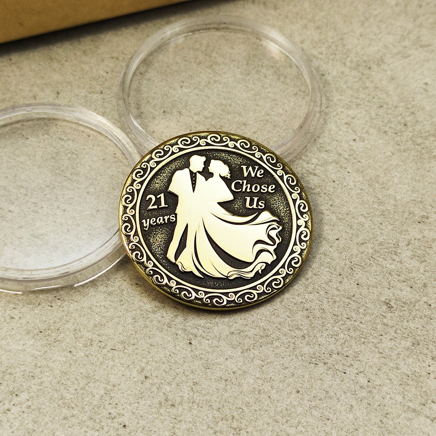 Engraved brass 21st anniversary token, metal coin showing detailed relief and decorative border.