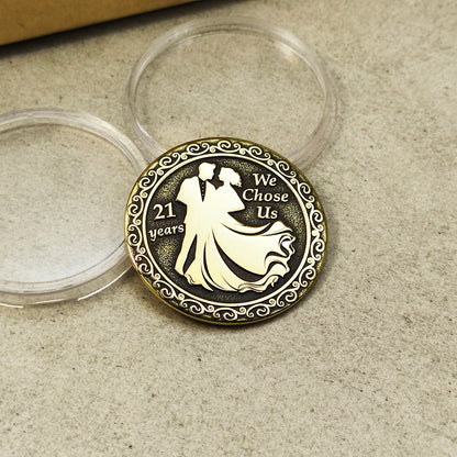 Engraved brass 21st anniversary token, metal coin showing detailed relief and decorative border.