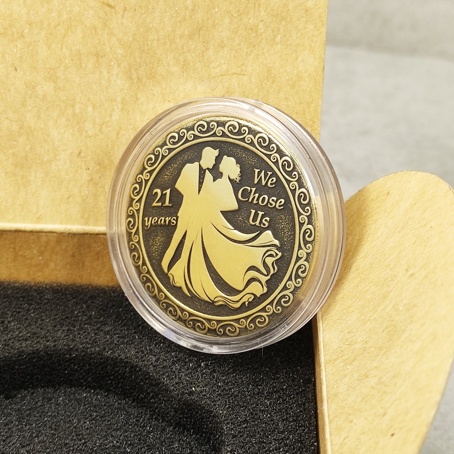 21st wedding anniversary brass coin inside a craft paper gift box with black foam insert, personalized commemorative gift.