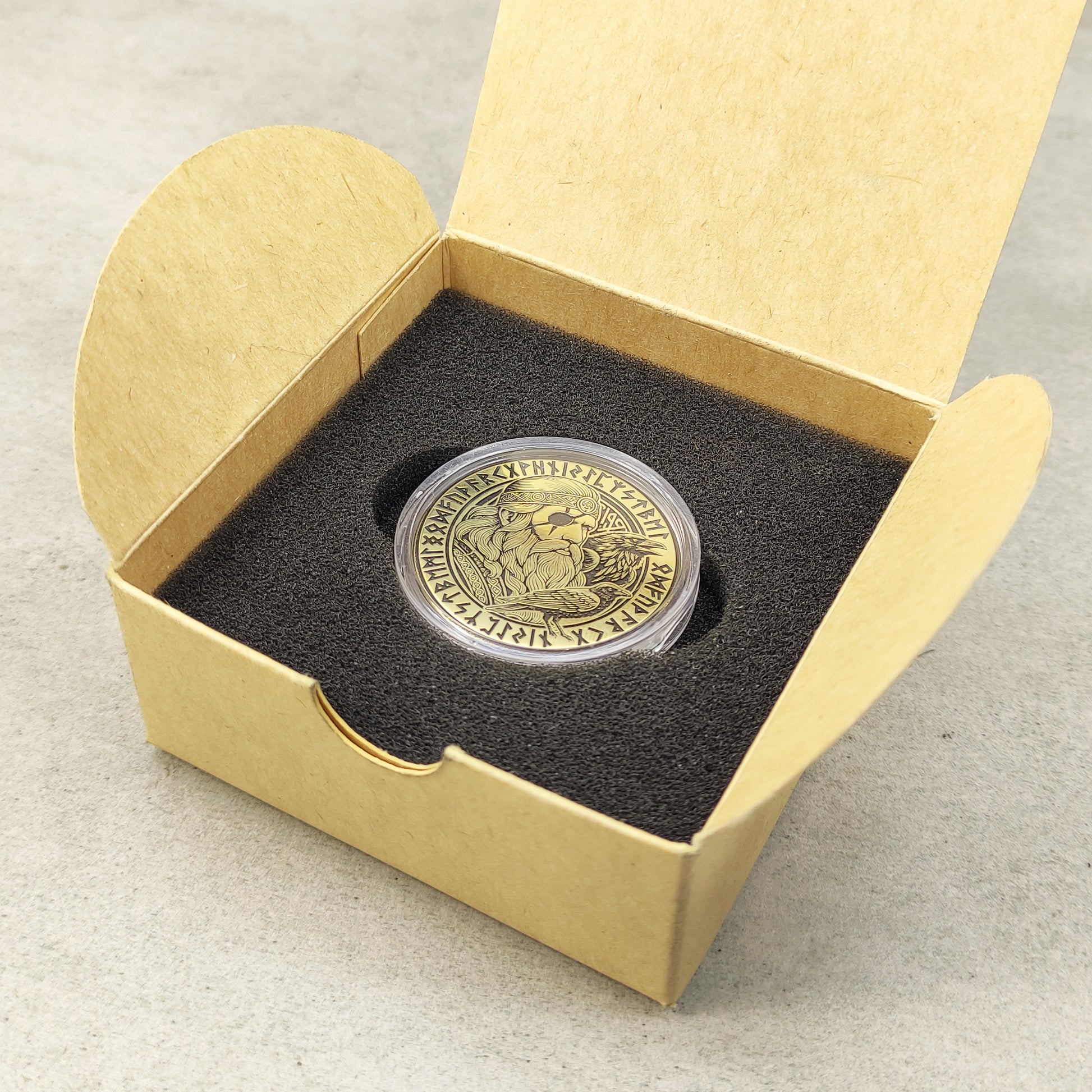 Handmade Viking Odin brass token in a black foam insert inside a craft box, premium personalized gift for Norse fans.