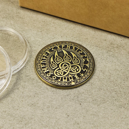 Close-up of the Scandinavian brass talisman with intricate runic circle and bear claw design.