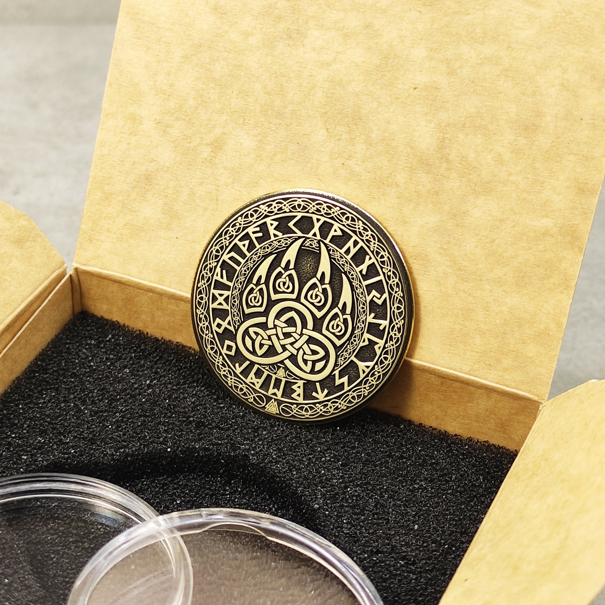 Reverse side of the brass Viking coin with engraved Strength, Courage, and Protection text.
