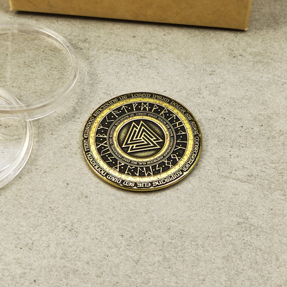 Top view of a brass Norse Valknut amulet coin featuring detailed runic circle engraving and high-contrast antique finish.