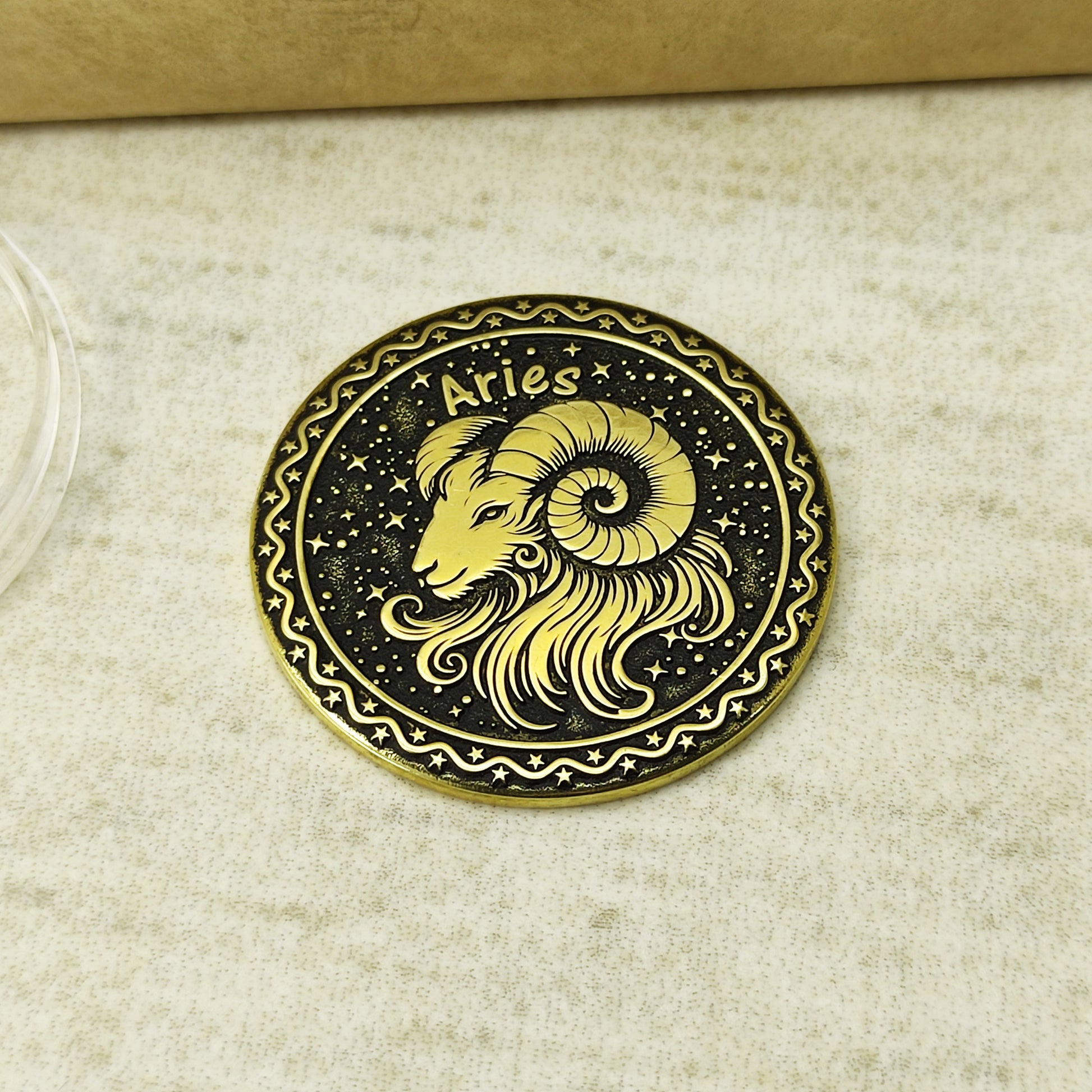 Detailed view of the Aries zodiac brass medal, highlighting the intricate 3D-style engraving and dark recessed patina on the polished surface.