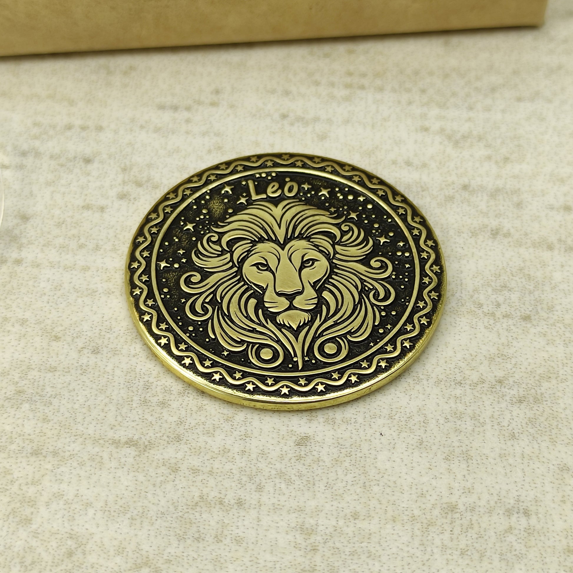 Detailed view of the Leo zodiac brass medal, highlighting the intricate 3D-style engraving and dark recessed patina on the polished brass surface.