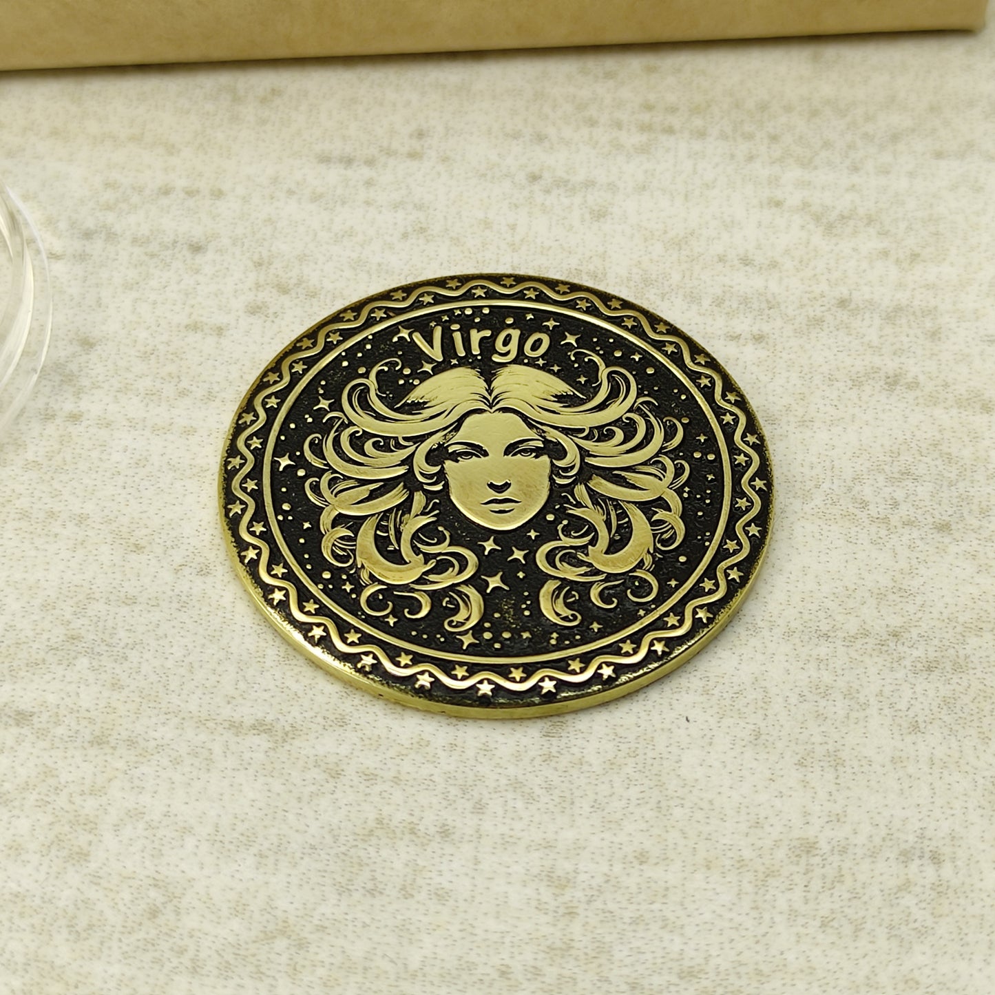 Detailed view of the Virgo zodiac brass medal, highlighting the intricate 3D-style engraving and dark recessed patina on the polished brass surface.