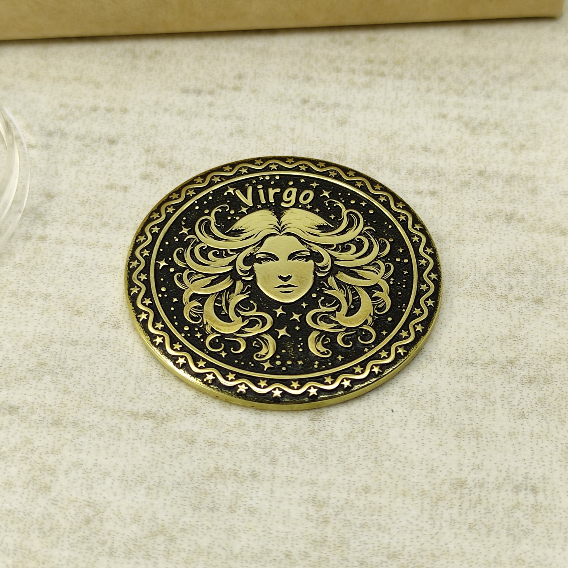 Detailed view of the Virgo zodiac brass medal, highlighting the intricate 3D-style engraving and dark recessed patina on the polished brass surface.