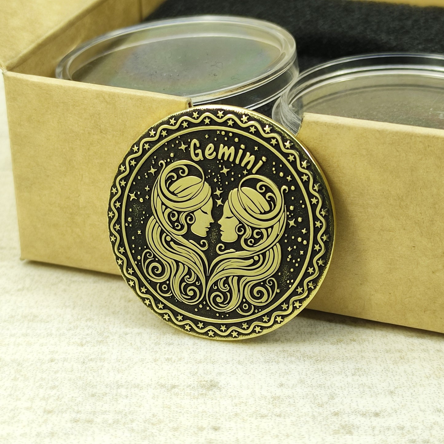Gemini zodiac brass medal presented with minimalist gift packaging, showcasing the 32mm diameter and premium metal quality of the custom engraved coin.
