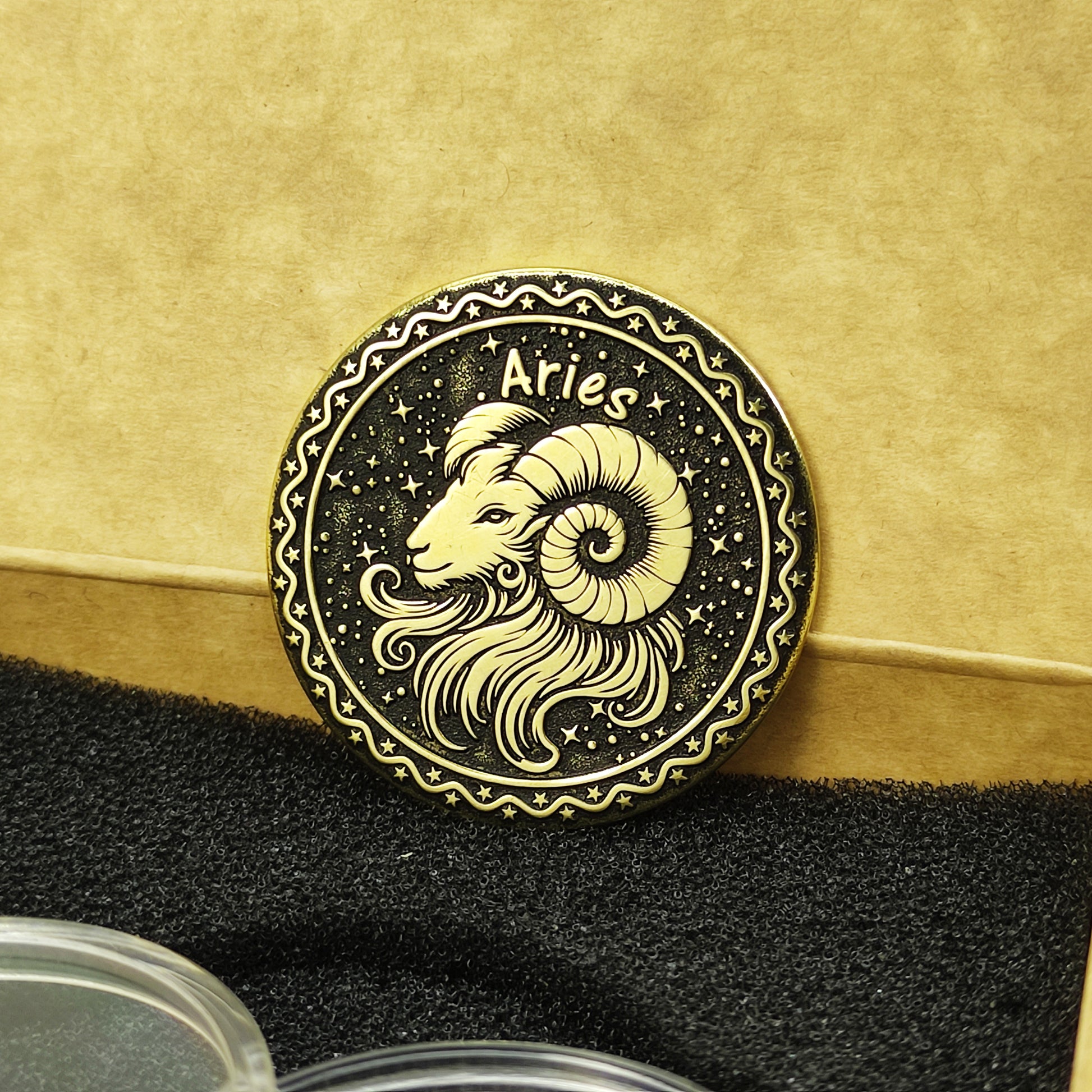 Aries zodiac brass medal presented with minimalist gift packaging, showcasing the 32mm diameter and premium metal quality of the custom coin.