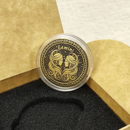 Top view of the Gemini zodiac medal in a protective acrylic capsule, handcrafted brass coin gift for astrology lovers with personalized laser etching.