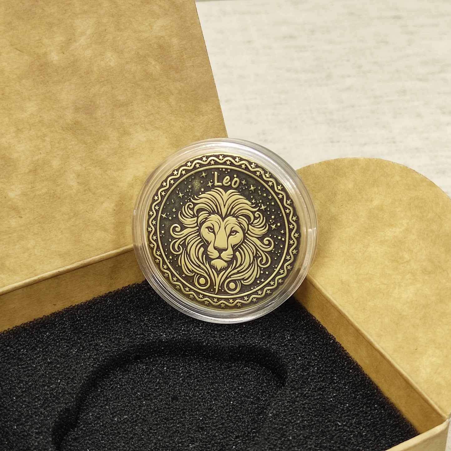 Top view of the Leo zodiac medal in a protective acrylic capsule, handcrafted brass coin gift for astrology lovers with personalized laser etching.