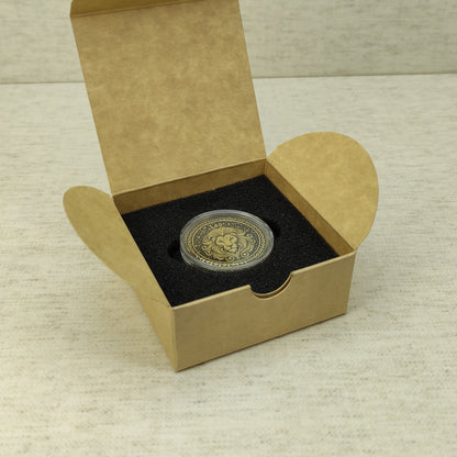 Leo zodiac brass medal in a small square craft gift box, professional presentation of a personalized astrology souvenir with dark patina finish.