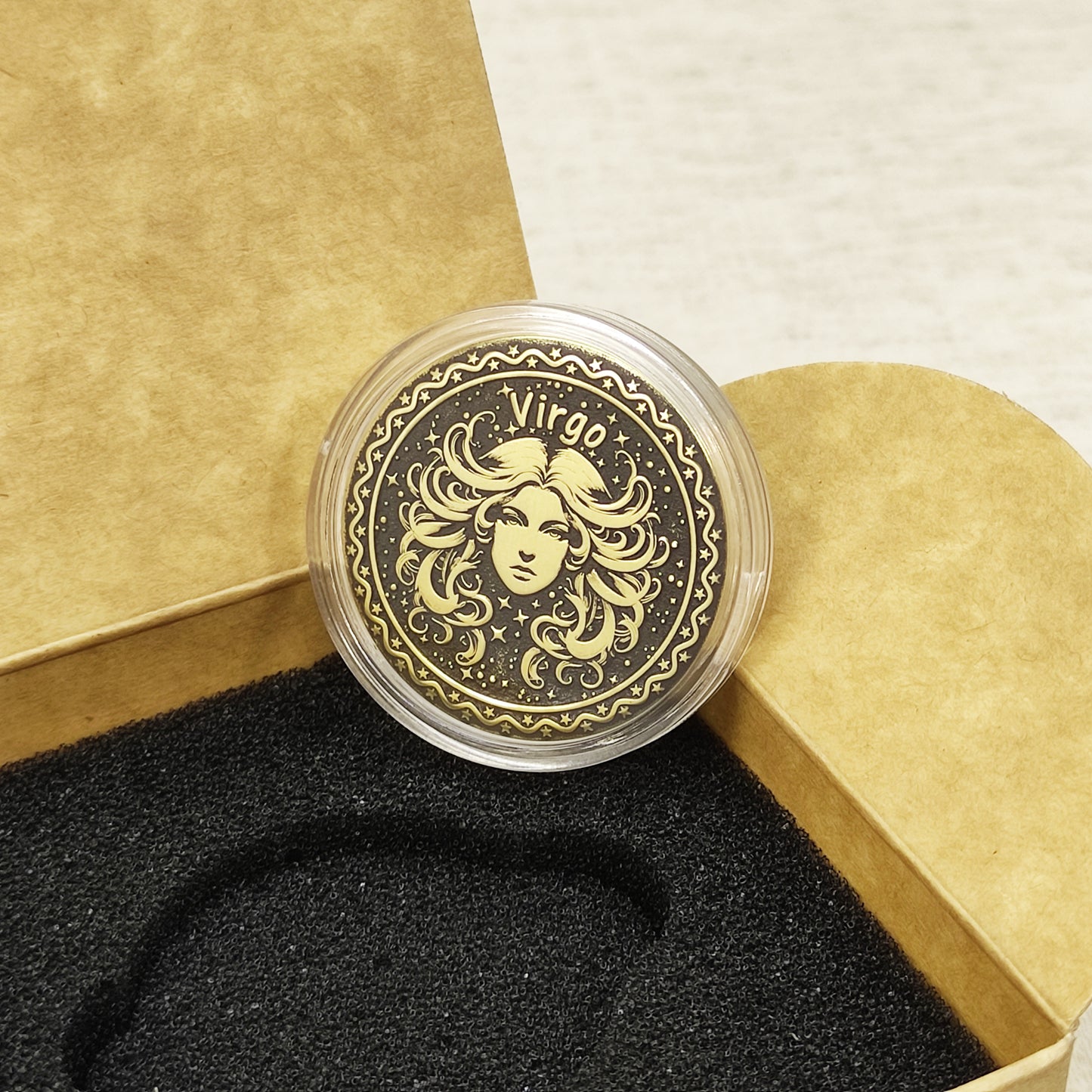 Top view of the Virgo zodiac medal in a protective acrylic capsule, handcrafted brass coin gift for astrology lovers with personalized laser etching.