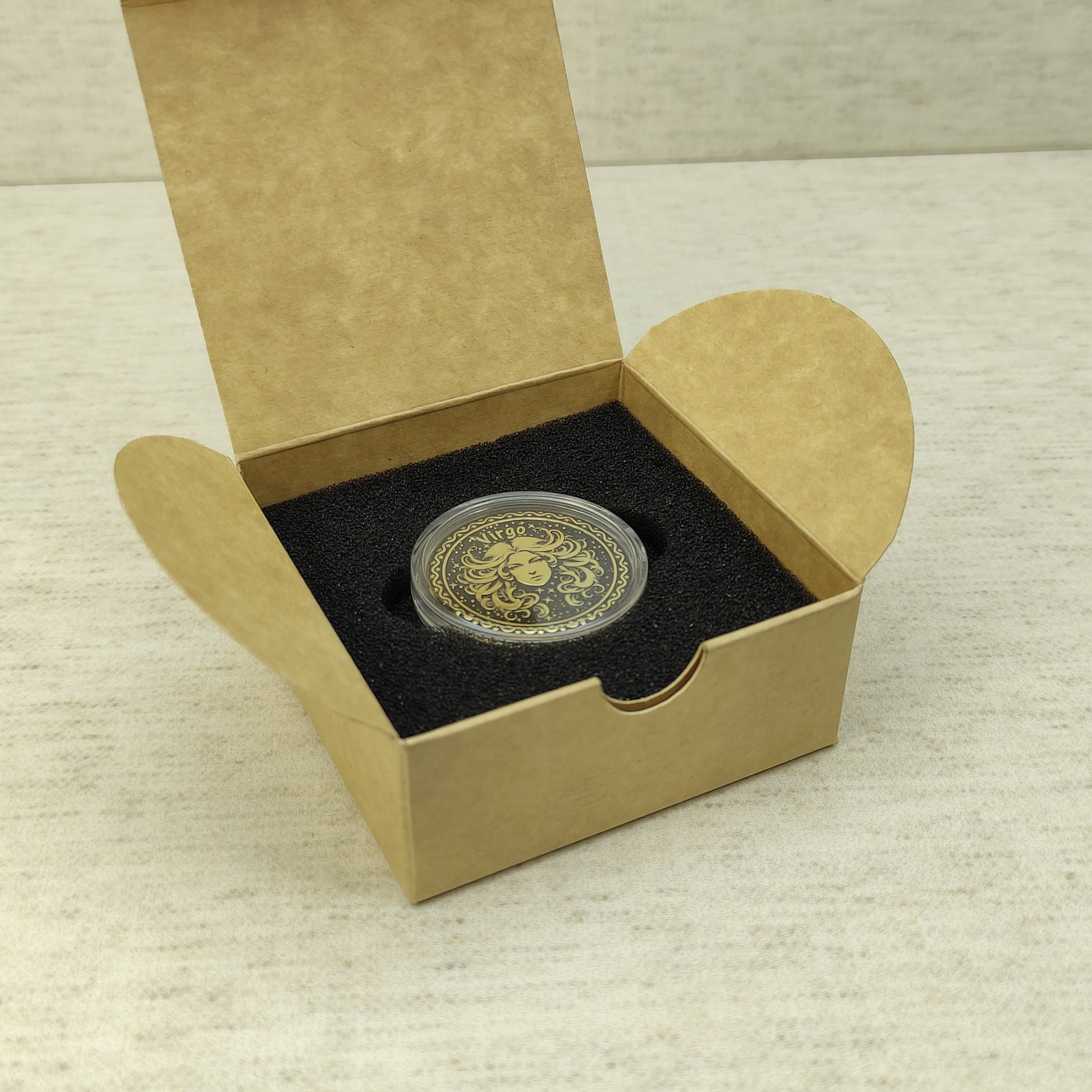 Virgo zodiac brass medal in a small square craft gift box, professional presentation of a personalized astrology souvenir with dark patina finish.