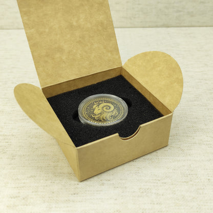 Aries zodiac brass medal in a small square craft gift box, professional presentation of a personalized astrology souvenir with dark patina finish.