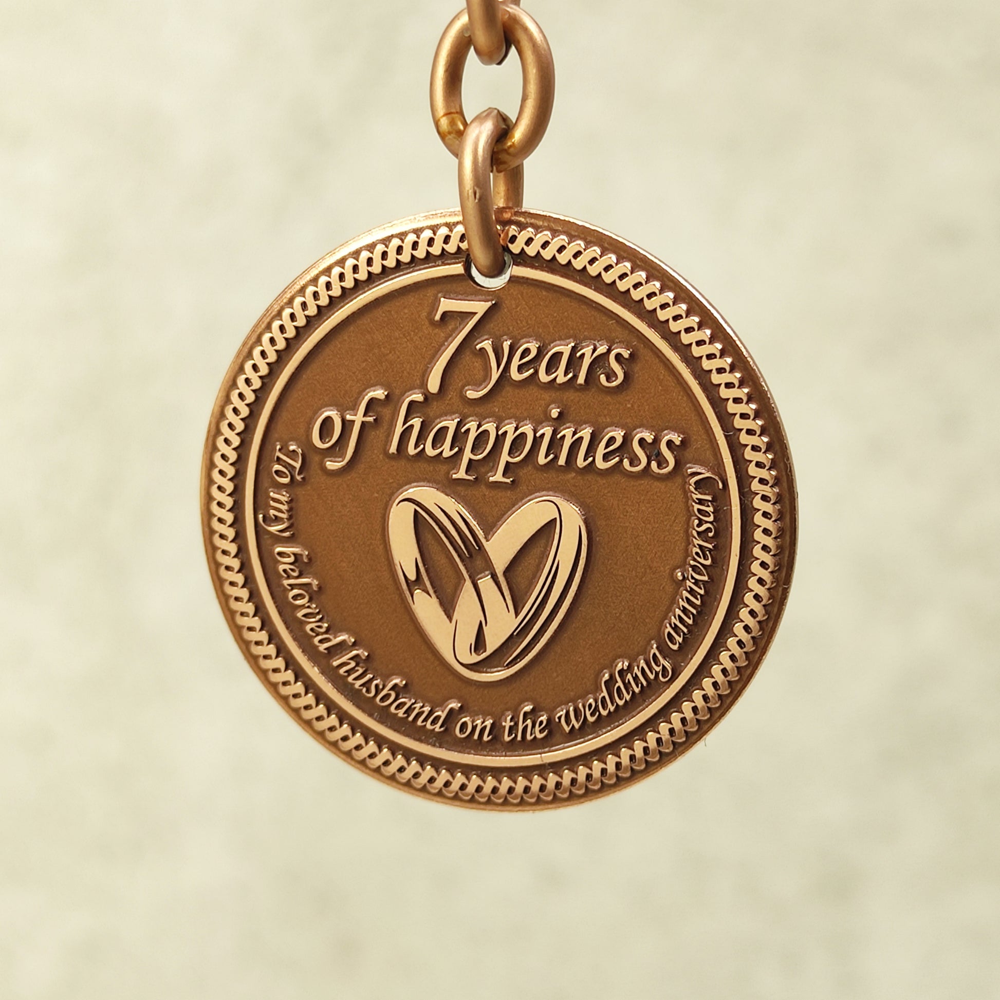 Pure copper 7th anniversary souvenir keychain for husband, personalized romantic gift with decorative border and antique patina, obverse view.