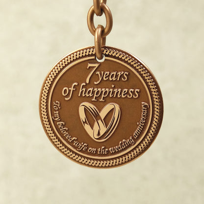 Pure copper 7th anniversary souvenir keychain for wife, personalized romantic gift with decorative border and antique patina, obverse view.