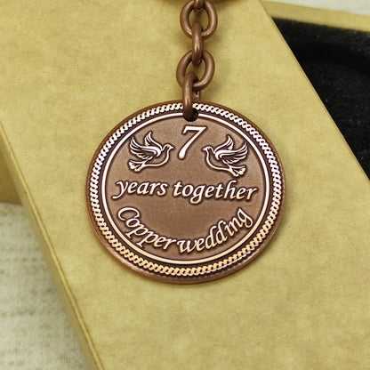Detailed view of 7th anniversary copper medallion showing deep etching and professional dark patina.
