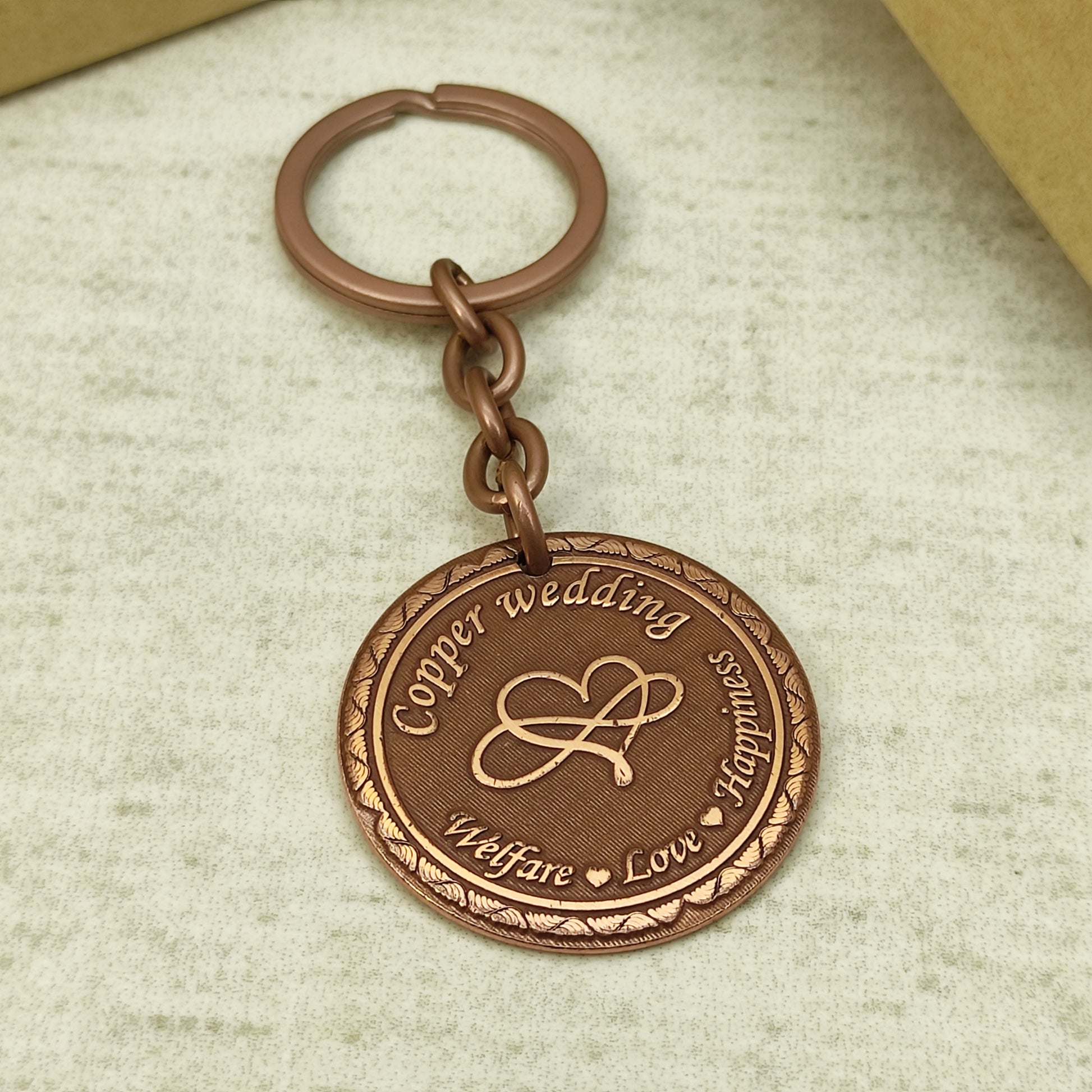 Custom engraved copper keychain for 7 years wedding anniversary with durable chain and metallic ring.