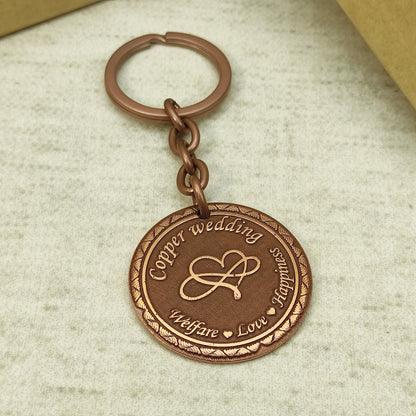 Custom engraved copper keychain for 7 years wedding anniversary with durable chain and metallic ring.