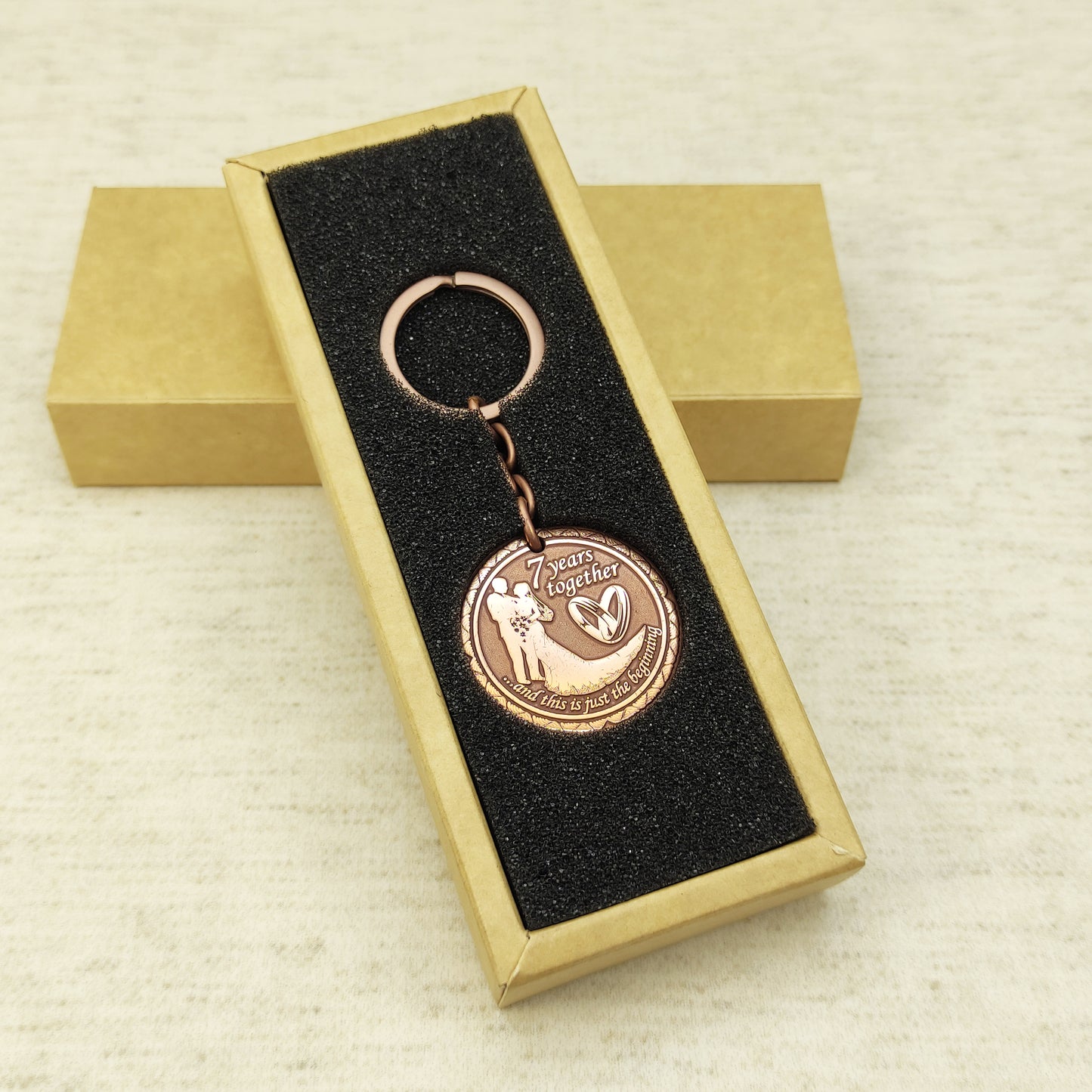 Personalized 7th anniversary copper keychain inside a premium gift box, ready to gift handmade souvenir with custom engraving.