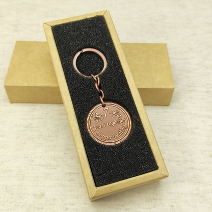 Customized 7 years copper wedding anniversary keychain in an elegant black foam insert gift box.