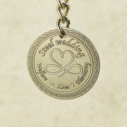Close-up of handcrafted stainless steel coin pendant for steel anniversary featuring decorative circular borders.