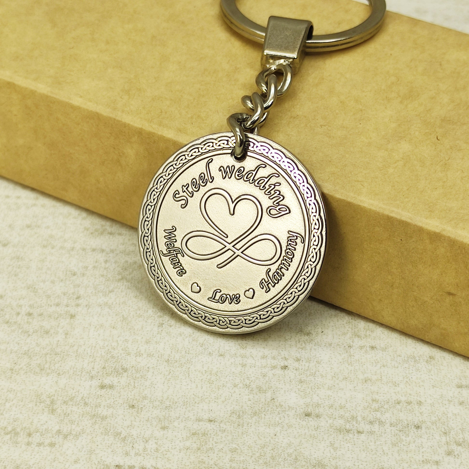 Detailed view of 11th anniversary steel medallion showing high-precision laser engraving on metallic surface.