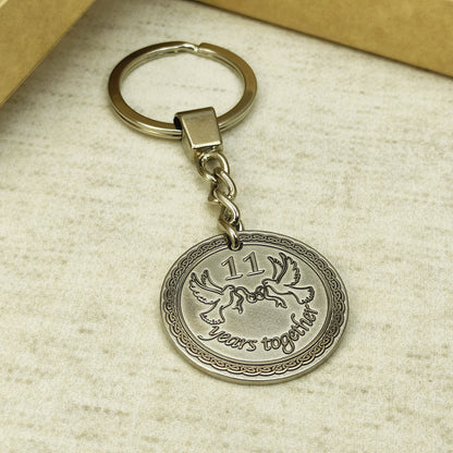 Custom engraved steel anniversary keychain for couples with durable metal chain and ring.