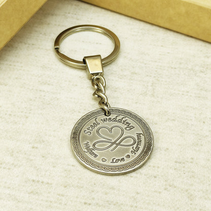 Custom engraved stainless steel keychain for couples with durable metal chain and polished finish.